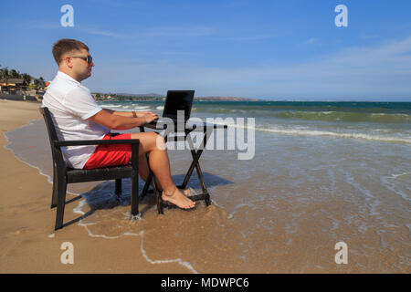 Business Man Working on Tropical Beach Stock Photo