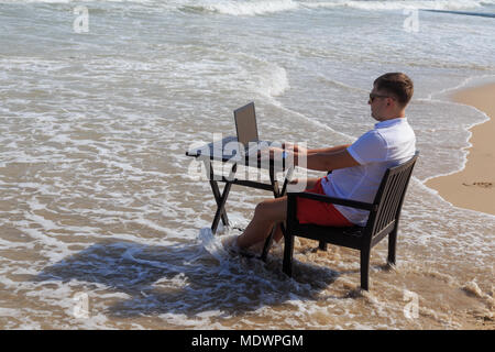 Business Man Working on Tropical Beach Stock Photo