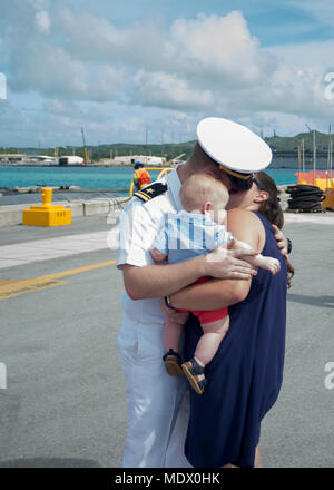 Lt. Jeremiah Roberts, assigned to Los Angeles-class attack submarine USS Asheville (SSN 758), receives the 'First Kiss' from his wife Pam and son Joshua during the submarine's arrival celebration at Naval Base Guam. Asheville replaced USS Chicago (SSN 721) as Guam's fourth forward-deployed submarine. (U.S. Navy photo by Culinary Specialist Submarines Seaman Jonathan Perez/RELEASED) Stock Photo