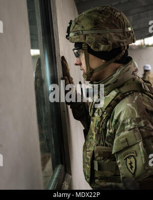 U.S. Army 2nd Lt. Maxwell Cormier, a paratrooper assigned to 3rd Battalion, 509th Parachute Infantry Regiment, 4th Infantry Brigade Combat Team (Airborne), 25th Infantry Division, U.S. Army Alaska, observes M67 fragmentation grenade live fire training at Kraft Range on Joint Base Elmendorf-Richardson, Alaska, Dec. 12, 2017. A ‘pit’ noncommissioned officer supervised the Soldiers throwing grenades to maintain a safe instructional environment, enforce precaution standards, and direct them on proper handling of explosives. The fragmentation hand grenade has a lethal radius of five meters and can  Stock Photo