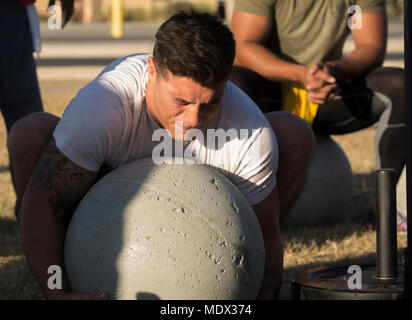 U.S. Marine Corps Cpl. Noah Diaz, an Aviation Ordnance Technician assigned to Marine Aviation Logistics Squadron 13, stationed at Marine Corps Air Station (MCAS) Yuma, Ariz., lifts an Atlas Stone to practice for the Strongman Competition Dec. 15, 2017 on the station parade deck. Atlas Stones are large balls of concrete used to test strength. The practice is to prepare for the Bull of the Desert Strongman Competition slated Feb. 17, 2018 in Yuma, Ariz. (U.S. Marine Corps photo by Lance Cpl. Sabrina Candiaflores) Stock Photo