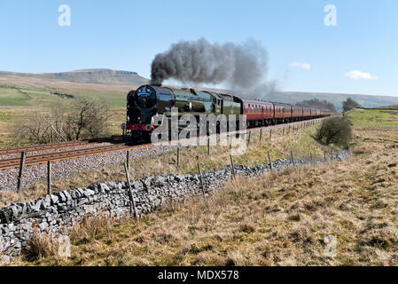 Ribblesdale, North Yorkshire, UK. 20th April 2018. Steam locomotive 'British India Line' hauls The Great Britain XI round the UK rail tour. Seen here on the tour section between York and Carlisle at Selside, in Ribblesdale, on the Settle-Carlisle railway line, 20th April 2018. Built for the Southern Railway in 1945 British India Line is one of the Merchant Navy class locos, all of which were named after shipping lines. The locomotive has been recently restored. In the background is Pen-y-ghent peak in the Yorkshire Dales National Park. Credit: John Bentley/Alamy Live News Stock Photo