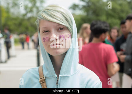 Austin, Texas, USA. 20th Apr, 2018. SHANTI CORNELL, 17 a student of Cedar Creek High School proudly wears a 'No More' slogan painted on her face to protest gun violence joining thousands of fellow students at the Texas State Capitol on the 19th anniversary of the Columbine High School massacre. Credit: Sandy Carson/ZUMA Wire/Alamy Live News Stock Photo