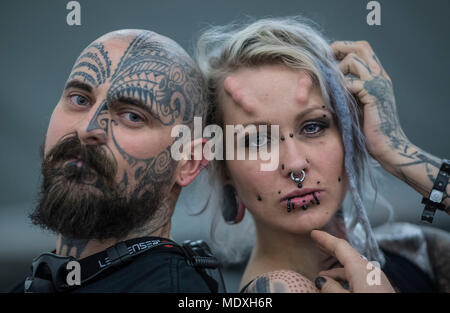 Frankfurt, Germany. 21st April, 2018.  Suma (r) and her partner Dimistay present their tattoos at a tattoo convention where tattoo artists and enthusiasts travel from far and wide to exchange ideas, techniques and knowledge. Photo: Boris Roessler/dpa Credit: dpa picture alliance/Alamy Live News Stock Photo