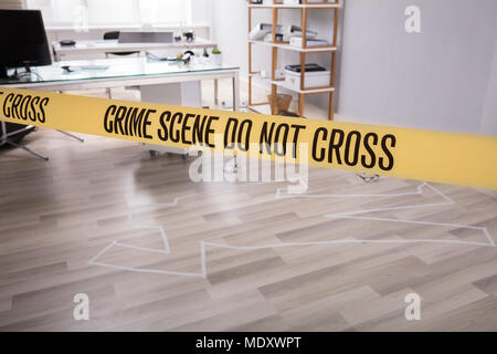 Yellow Crime Scene Tape Near Chalk Outline Of Murdered Victim Stock Photo