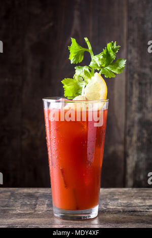 Bloody Mary cocktail in glass on wooden table. Stock Photo