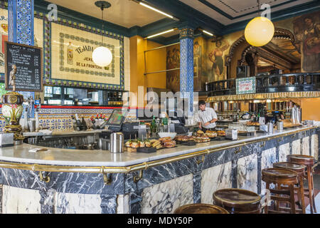 Cafe Iruna and a worker behind the counter with food on display, Bilbao, Spain Stock Photo