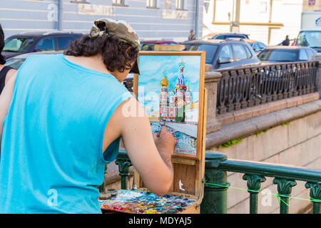 Saint-Petersburg, Russia - July 27, 2016: The artist paints the temple of the Savior on the Blood Stock Photo