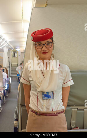 DUBAI - NOVEMBER 17, 2015: Emirates cabin crew attendant on board of Airbus A380. Stock Photo