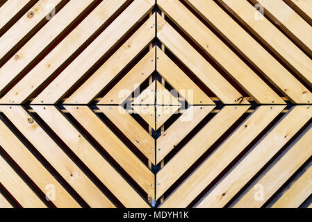 Symmetrical diamond background pattern with natural wood in concentric squares or rectangles viewed from above Stock Photo