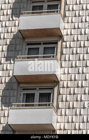 Luxury apartment facade with small balconies and stone brick exterior ...