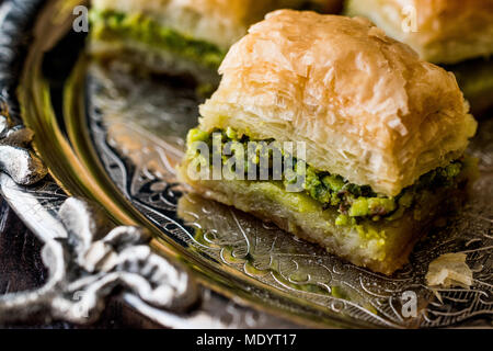 Turkish Dessert Baklava with pistachio on silver tray. Dessert Concept. Stock Photo