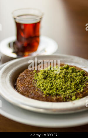 Turkish Dessert Kunefe with Pistachio Powder. Traditional Food. Stock Photo