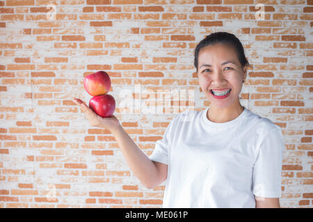 Two apples in asian woman hand and her smile happyness Stock Photo