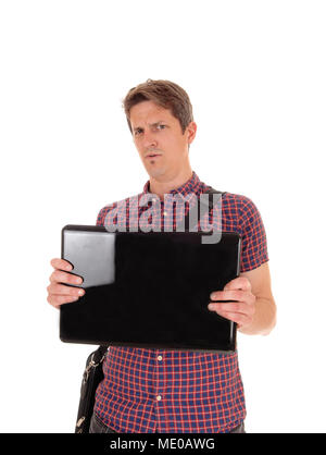 A suspicious man in a checkered shirt holding up his laptop questioning what he sees on the screen, isolated for white background Stock Photo
