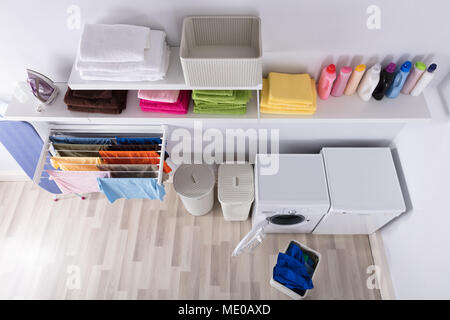 Interior Of Utility Room With Washing Machine And Drying Clothes Stock Photo