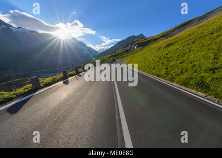 Mountain road with sun at Grossglockner High Alpine Road in the Hohe Tauern National Park, Carinthia, Austria Stock Photo