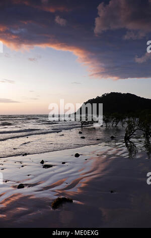 Silhouette of coastal shoreline and beach at Cape Tribulation at sunrise in Daintree National Park, Australia Stock Photo