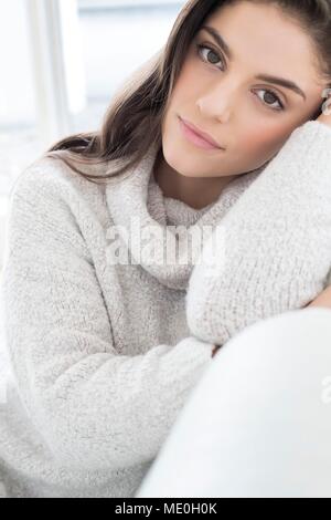 Young woman wearing knitted sweater, portrait.
