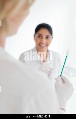 Doctor holding cervical smear equipment. Stock Photo