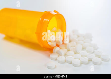 White pills spilling from bottle. Stock Photo