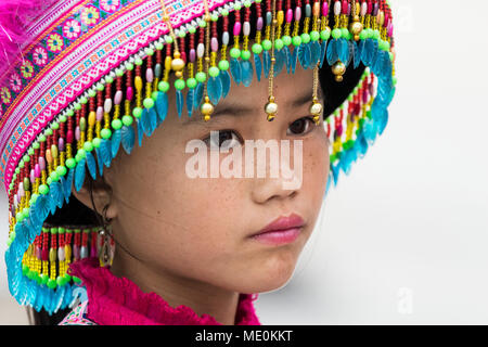 Portrait of a young Hmong girl wearing a colourful, decorative hat; Sapa, Lao Cai, Vietnam Stock Photo