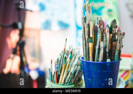 Painting Studio tools. Set of artistic multicolor brushes in basket. Soft focus Stock Photo