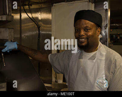 PORTLAND, Ore. (Dec. 13, 2017) - Andrew Leggett, 2nd Cook aboard the submarine tender USS Frank Cable, poses for an environmental portrait inside of the galley kitchen. Frank Cable, currently in Portland, Ore. for her dry-dock phase maintenance availability, conducts maintenance and supports submarines and surface vessels deployed to the Indo-Asia-Pacific region. (U.S. Navy photo by Mass Communication Specialist Randall W. Ramaswamy) Stock Photo