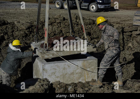 Engineering Installation vehicle training is a United States Air National Guard program conducted at Fort Indiantown Gap, Pennsylvania, focused on heavy equipment and rigging instruction. On December 13, 2017, students practiced guiding a maintenance hole cover while learning load weight estimation and chain and strap ratings. The archival image documents technical training at the Air National Guard Schoolhouse. Stock Photo
