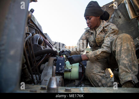 U.S. Army Pfc. Kiersten Letang a Multiple Launch Rocket System (MLRS) repairer with B Battery, 1st Battalion, 38th Field Artillery Regiment, 2nd Infantry Division/ROK-US works on an M993 Carrier Vehicle in South Korea, Dec. 8, 2017. Repairers are trained to quickly troubleshoot and fix the MLRS in any enviroment to ensure mission readiness at all times. (U.S. Army photo by Staff Sgt. Carl Greenwell) Stock Photo