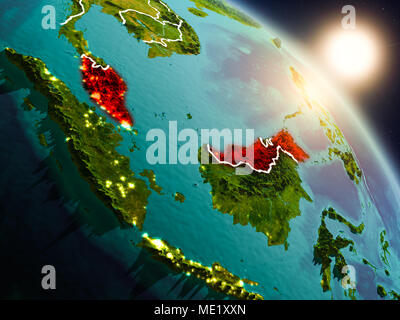 Sunset above Malaysia from space on planet Earth with visible country borders. 3D illustration. Elements of this image furnished by NASA. Stock Photo