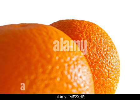 bright colored sides of two oranges on white background; far fruit is in focus, near is blurred Stock Photo