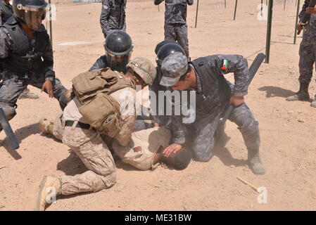 CAMP TITIN, Jordan (April 18, 2018) – U.S. Marines with Fleet Anti-Terrorism Security Team – Central Command and Jordanian 77th Marines Battalion train together in riot control measures during exercise Eager Lion 2018, April 18, 2018. Eager Lion is a capstone training engagement that provides U.S. forces and the Jordan Armed Forces an opportunity to rehearse operating in a coalition environment and to pursue new ways to collectively address threats to regional security and improve overall maritime security.  (U.S. Navy photo by Mass Communication Specialist 1st Class Sandi Grimnes Moreno/relea Stock Photo