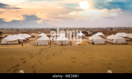 Desert sunset at Thar Jaisalmer Rajasthan with view of tourist tents used on desert safari. Stock Photo