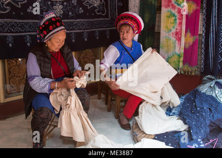 Dali, China - March 23, 2018: Bai women hand dyeing fabrics with indico blue Stock Photo