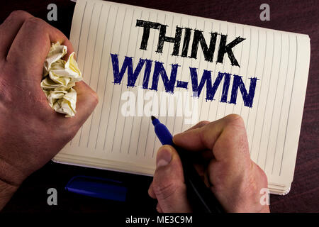 Writing note showing  Think Win-Win. Business photo showcasing Negotiation strategy for both partners to obtain benefits written by Man Notebook Book  Stock Photo