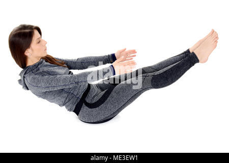 young woman doing yoga asana Navasana Boat pose Stock Photo