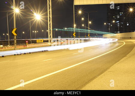Light trails from fast moving cars at night Stock Photo