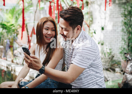 Young couple using a phone together Stock Photo