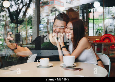 Lovely asian couple having coffee Stock Photo