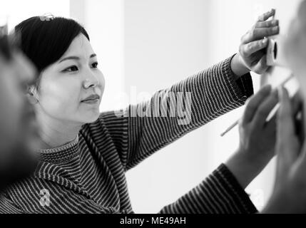 Asian couple measuring the wall Stock Photo