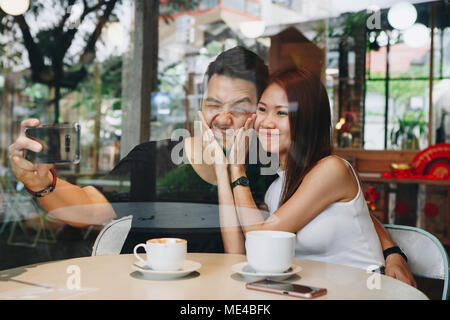 Lovely asian couple having coffee Stock Photo