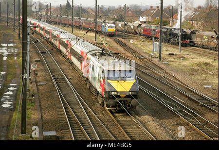 Virgin East Coast train hauled by 91111 'For The Fallen' approaching York station with loco 86259 'Les Ross' and steam charter service behind. Stock Photo