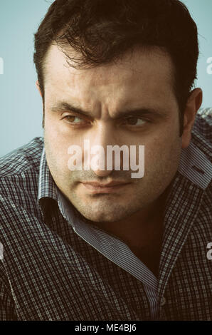 Portrait of a serious pensive Arab man looking away Stock Photo