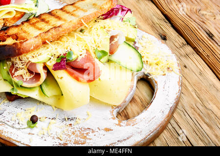 Sandwiches with beef, fresh vegetables and herbs on the cutting board Stock Photo