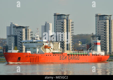 Cargo Ship heading down the River Thames in London Stock Photo