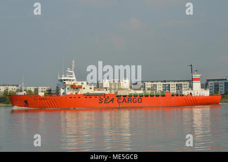 Cargo Ship heading down the River Thames in London Stock Photo