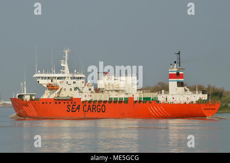 Cargo Ship heading down the River Thames in London Stock Photo