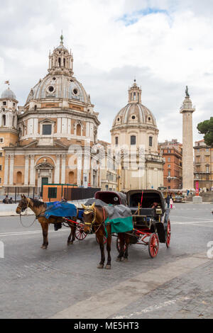 Rome, Italy - February 21, 2015: Two horse draw carriages wait for tourists at the steps of the Altare Della Patria in central Rome. Stock Photo