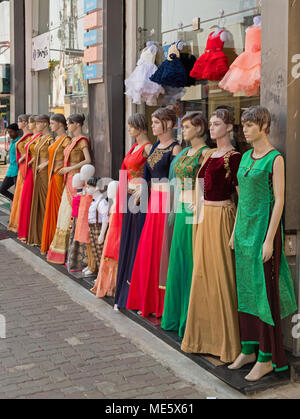 Mysore, India - March 3, 2018: An unidentified youth standing at the end of a row of mannequins outside a clothing store in the city centre Stock Photo